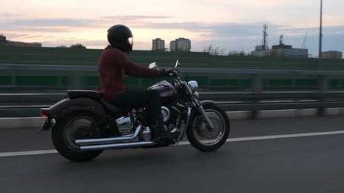 Motorcyclist Riding on Elevated Highway at Dusk