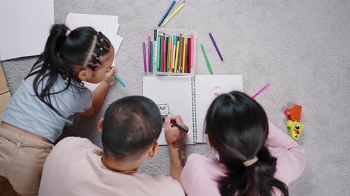 Family Drawing Together Indoors, Overhead Shot