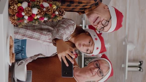Family Take Christmas Selfie Together at Home