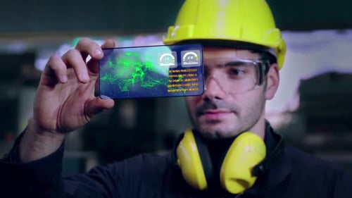 Un ouvrier d'usine utilise un futur dispositif d'écran holographique pour contrôler la fabrication