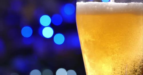 Glass of Champagne or Beer in a Glass on the Background of Holiday or New Year's Lights