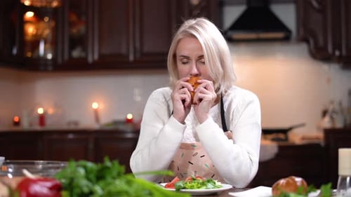 Blonde Adult Woman Eating Salad in a Kitchen