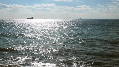 Beautiful View of Sea or Ocean with Small Waves Sun Reflects Off Surface of Water