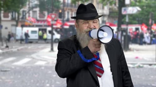 Man Speaks into Megaphone in Urban Setting