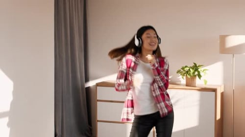 Woman Dancing and Listening to Music at Home