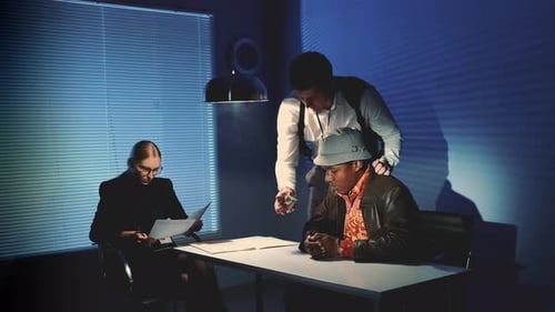Intense Interrogation in a Dark, Blue-Lit Room