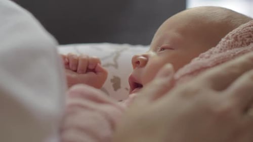 Adorable Newborn Opens Eyes Under Gentle Touch