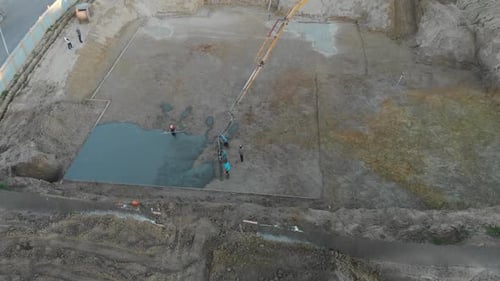 Construction Workers Pouring Concrete Aerial Shot