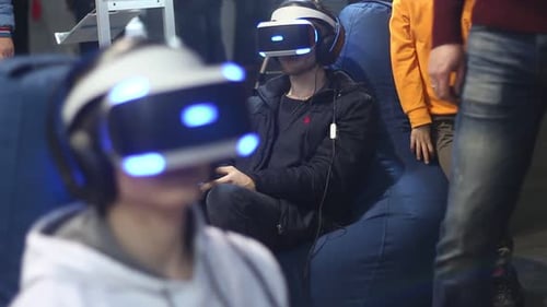 People In Virtual Reality Helmets Play