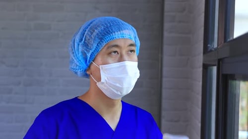 Healthcare Worker Puts on Protective Eyewear in Hospital