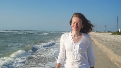 Girl Walking Along Sea Shore