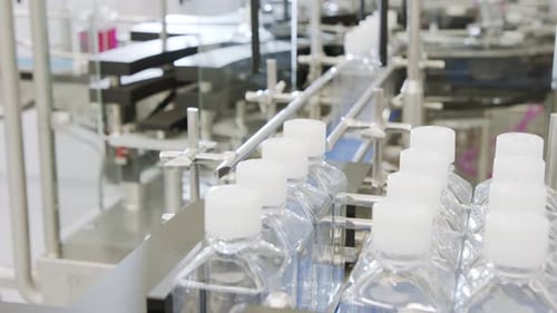 Automated pharmaceutical manufacturing line, bottles filled with liquid