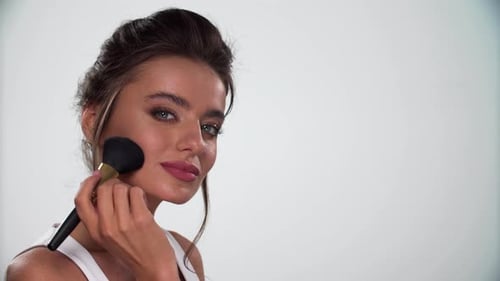Beauty Face Makeup. Woman Applying Blush On Skin With Brush