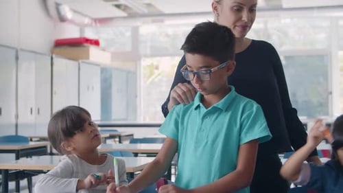 Female School Teacher Watching Diverse Group of Pupils