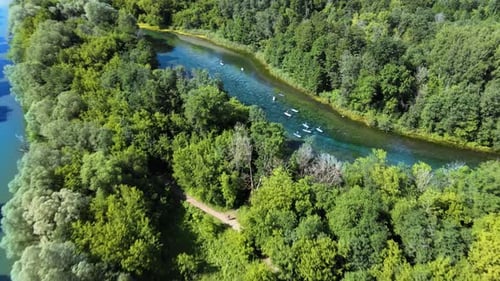 Summer active vacation concept. Athletic people on paddles rowing on the river