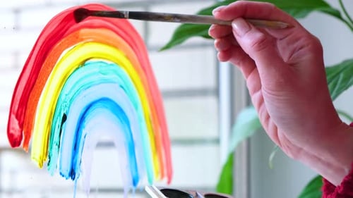 Hand Painting Rainbow on Window with Watercolor Paint