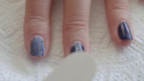 Close Up Woman Remove Old Gel From Nails with Nail File. Woman Getting Nail Manicure.