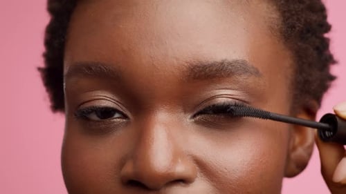 Young Woman Applying Mascara in Close Up