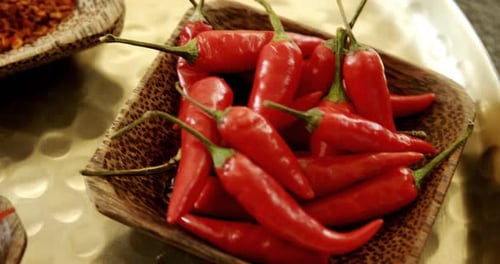 Vibrant Red Chili Peppers and Flakes in Bowl