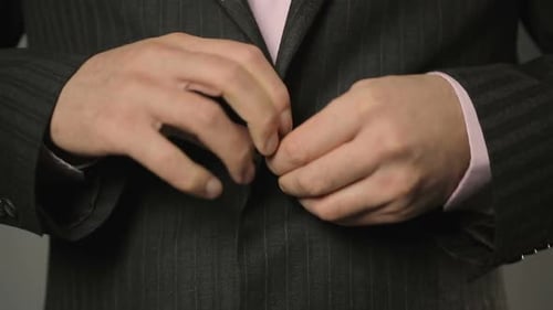Office Worker in Suit Fastening Upper and Lower Buttons on His Jacket Close Up