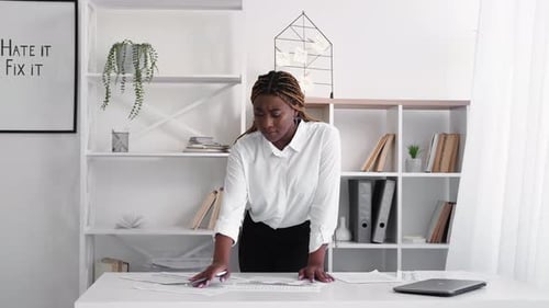 Young Woman Working at Desk in Bright Office