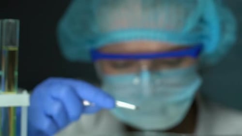 Pharmacist Studying Green Powder Plant Extract, Holding Sample With Forceps