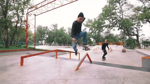 Two Skateboarders in Skate Park Doing Tricks Slow Motion