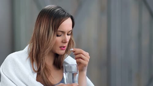 Unhealthy Young Woman with Flu Symptoms Drink Tablet with Water Close Up