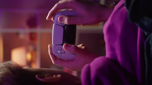 Adult Hands Using Video Game Controller