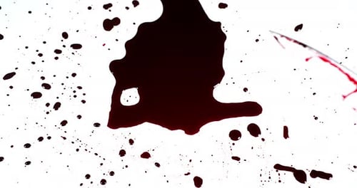 Knife Covered in Blood Lying on White Surface