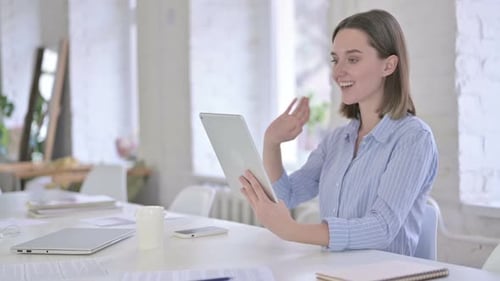 Woman On Video Call with Tablet in Office