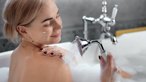 Woman Relaxing in Luxurious Bubble Bath with Shower