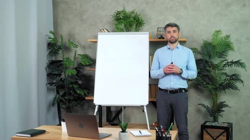 Man Explaining Lesson Standing by White Board