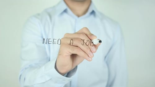 Man Writes Need a Job on Transparent Surface
