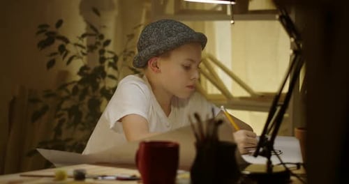 Young Artist Drawing at Table