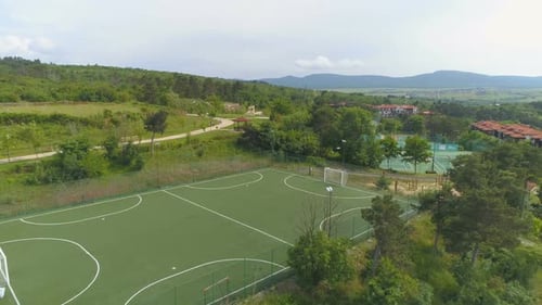 Aerial above Football field and tennis courts in luxurious resort