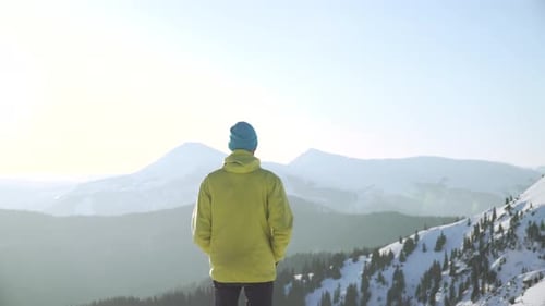 Man Enjoys Mountain View in Winter Landscape