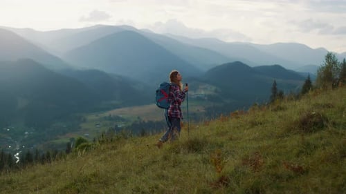 Woman Hiking Through Scenic Mountain Landscape