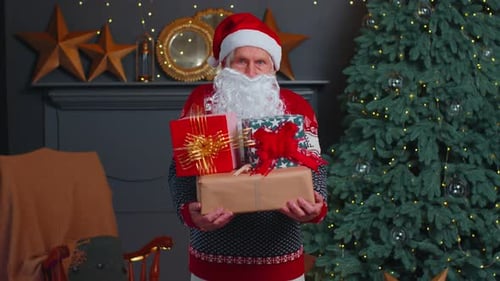 Senior Man Dressed as Santa Holding Gifts