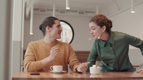 Young Man and Woman Meeting in Restaurant