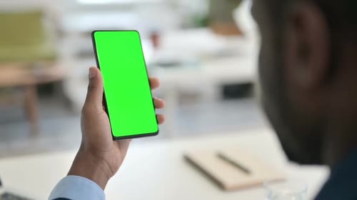 Businessman Using Smartphone with Green Chroma Key Screen