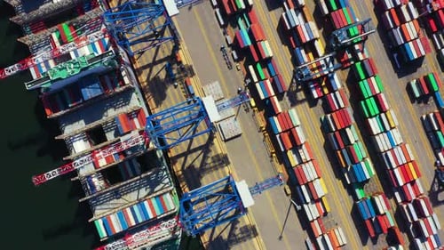 Container ship in export and import business and logistics. Shipping cargo to harbor by crane. Water