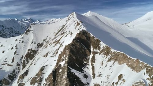 Aerial View of Snowy Mountain Peaks in Winter