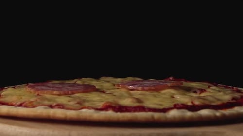 Pepperoni Slices Falling onto Cheese Pizza Close Up