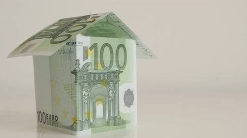 Concept of real estate building with EU paper money 4K 2160p 30fps UltraHD tilting footage - Clos