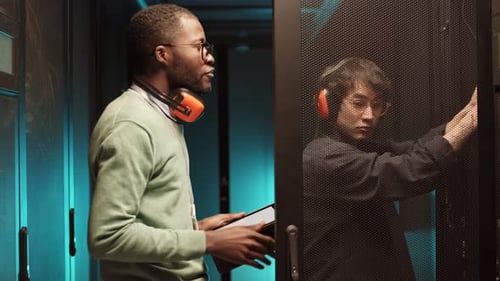 Man Using Tablet in Server Room