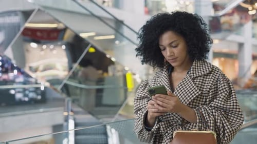 Woman Using Smartphone at Shopping Center