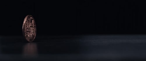Crypto Coin Spins on Black Reflective Surface
