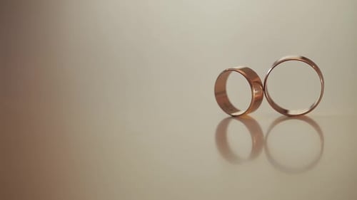 Wedding Gold Rings Roll To Each Other. Close-up, Macro Shot