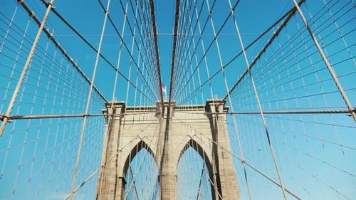 Walk on the Brooklyn Bridge. Pylons and Ropes of the Bridge Against the Serene Blue Sky. Pov Video